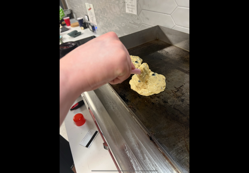 Pancakes being put on the stove 