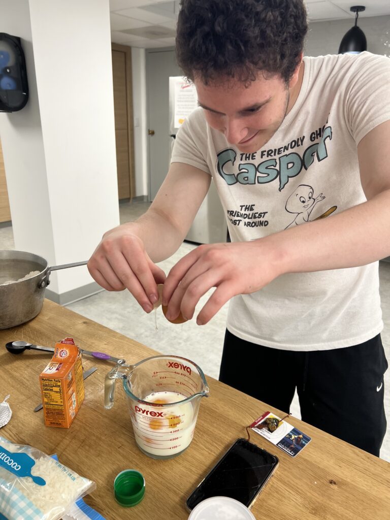 Very sexy man cracking an egg 