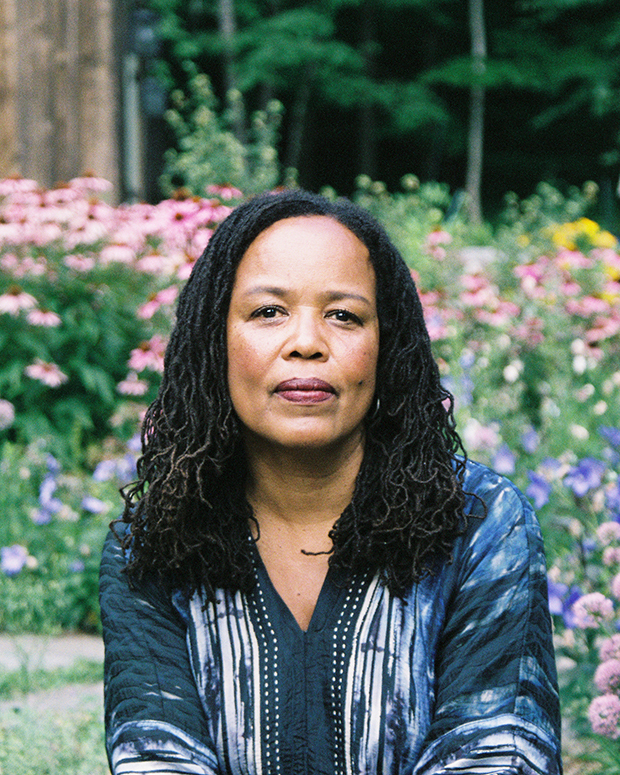Saidiya Hartman sitting in front of flowers